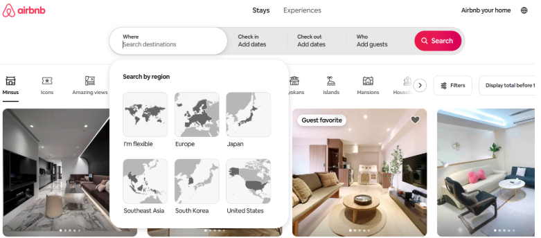  “Airbnb homepage with destination search bar and regional filter options including Europe, Japan, Southeast Asia, South Korea, and the United States, alongside listings with photos of stylish rental interiors.