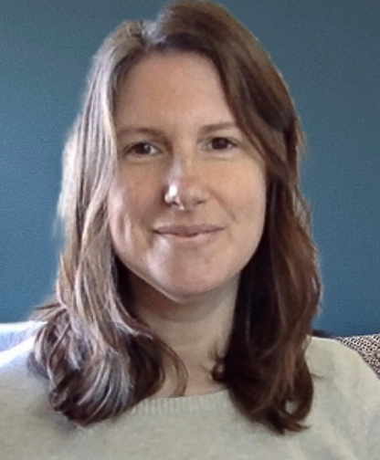 Tutor Laura smiling softly indoors against a teal background, wearing a light-colored sweater.